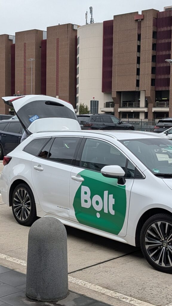 Bolt ride-hailing car spotted at the Uber pickup zone at Frankfurt Airport Terminal 1 — March 2026