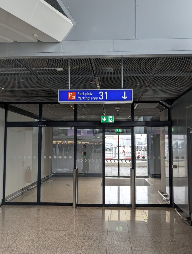 Parking Area 31 exit sign inside Frankfurt Airport Terminal 1 — the door that leads directly to the Uber pickup zone 